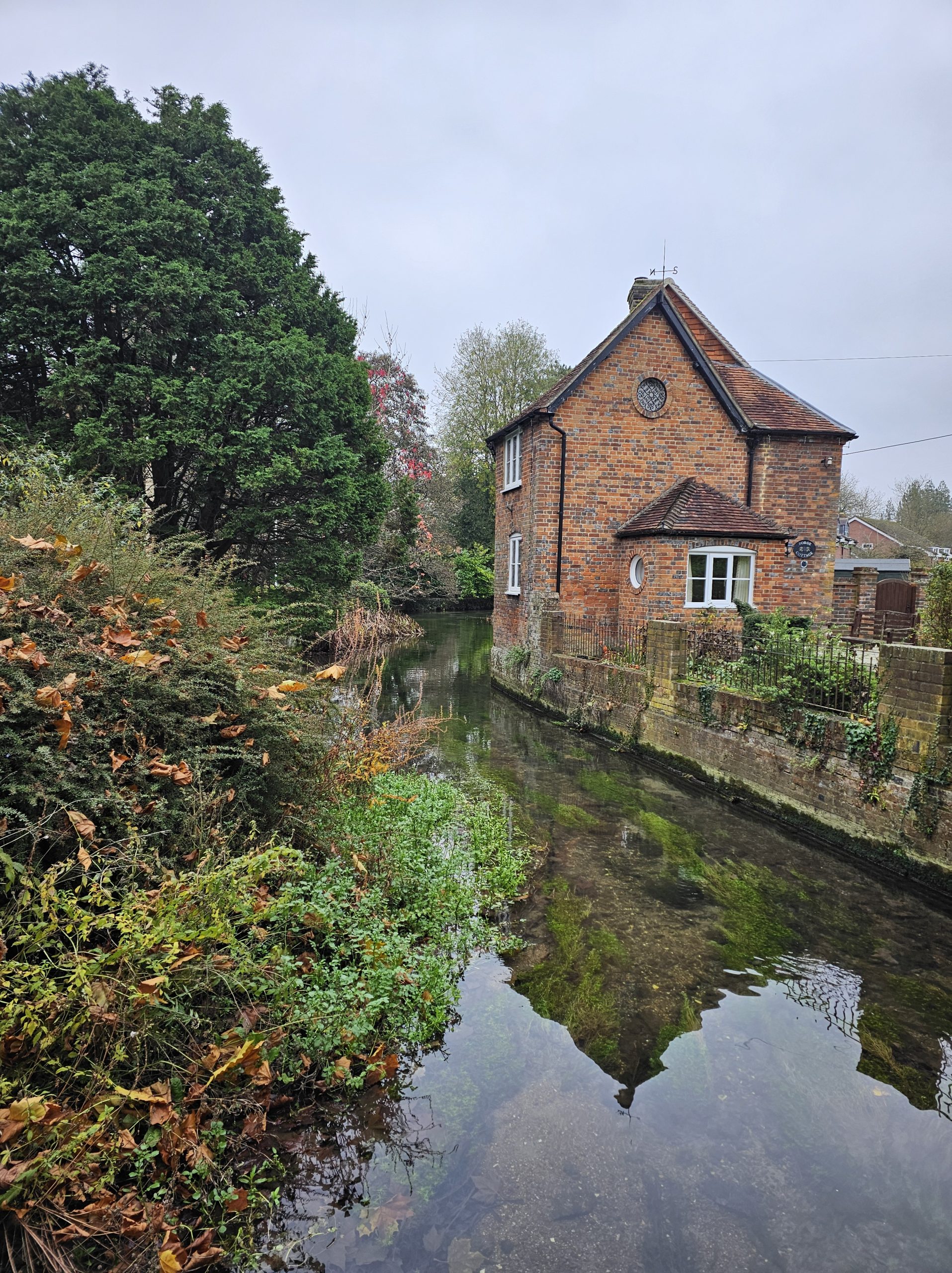 Tranquil flow of the River Dun with a charming house nestled by the water’s edge.