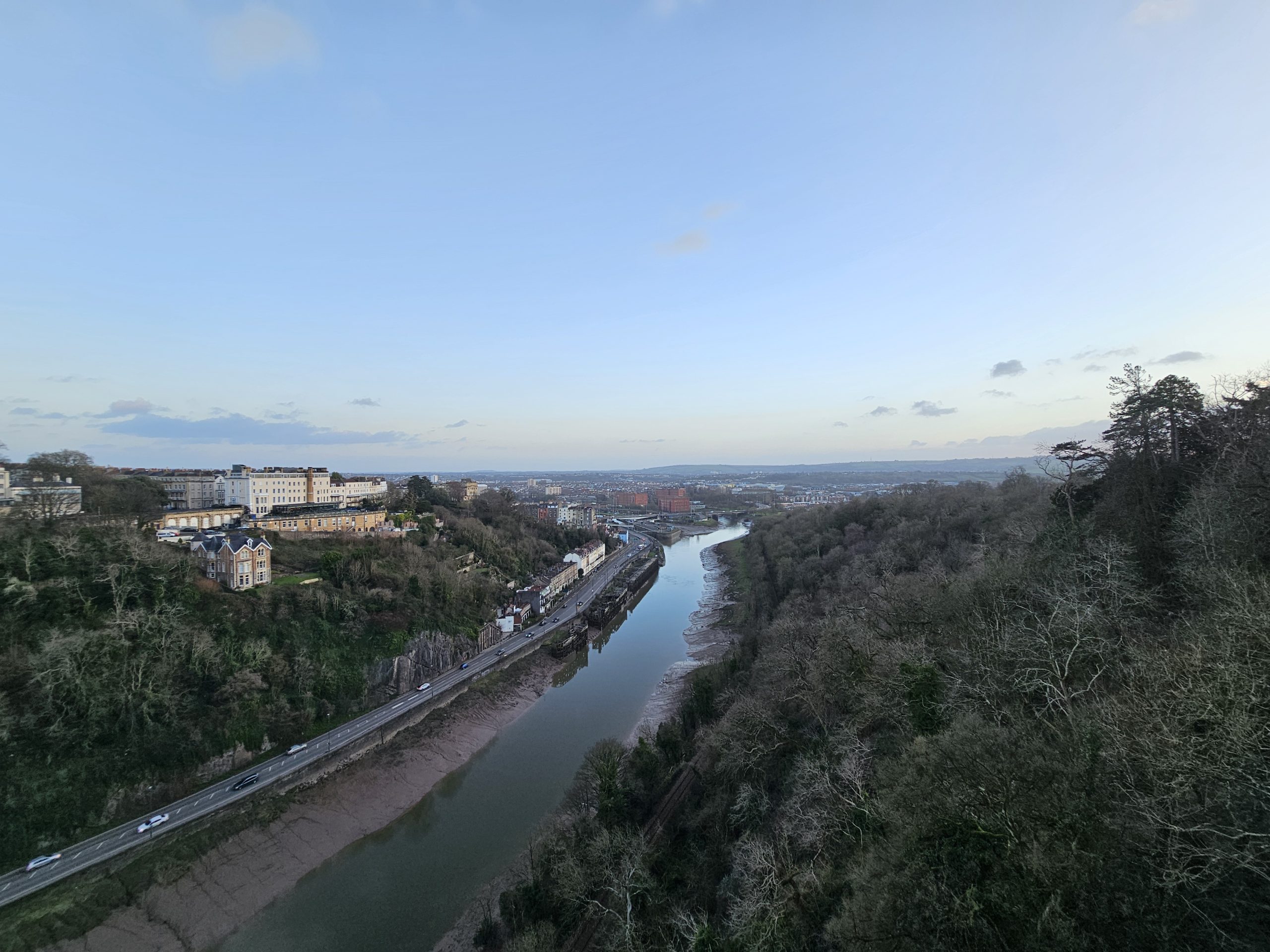 A winter view of Bristol's landscape from the Clifton Suspension Bridge, with the River Avon below and the city stretching into the distance.