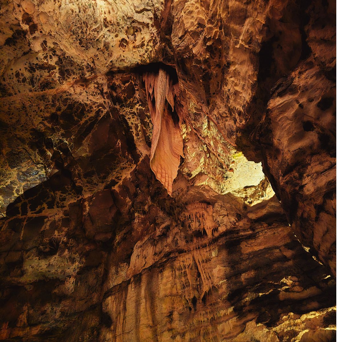 Rock formation inside Dan-yr-Ogof cave resembling a dragon’s wing, highlighting Wales’s legendary connection to dragons.