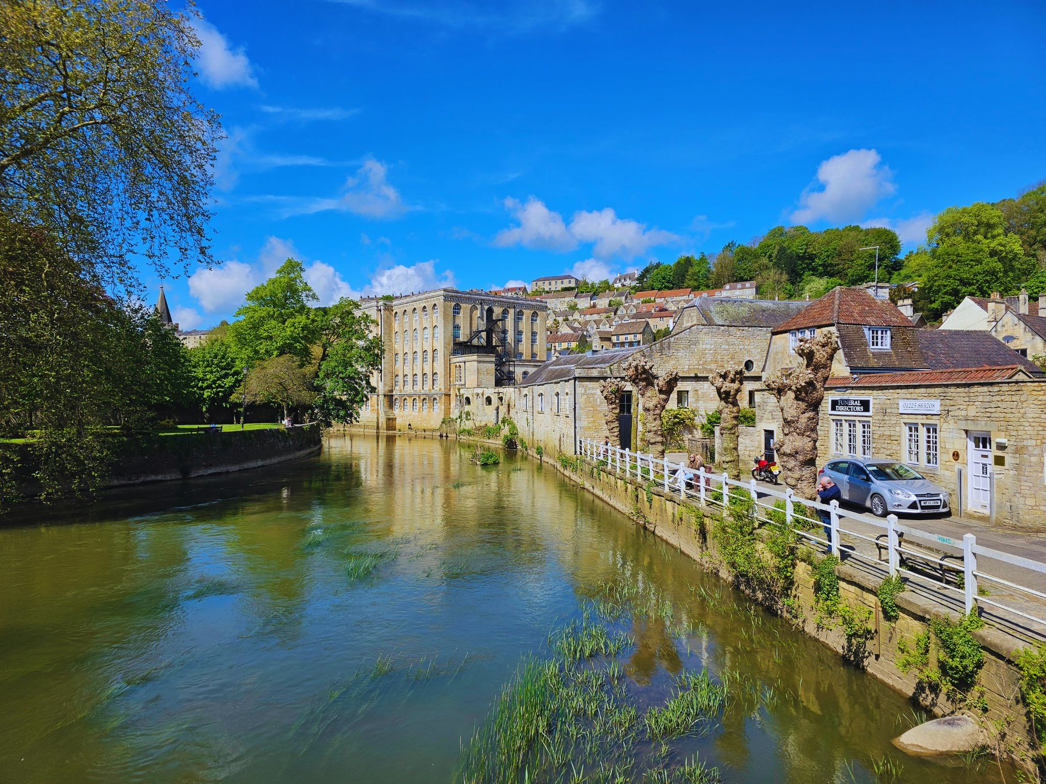 View of the River Avon and historic buildings in Bradford-on-Avon, seen from the pedestrian bridge